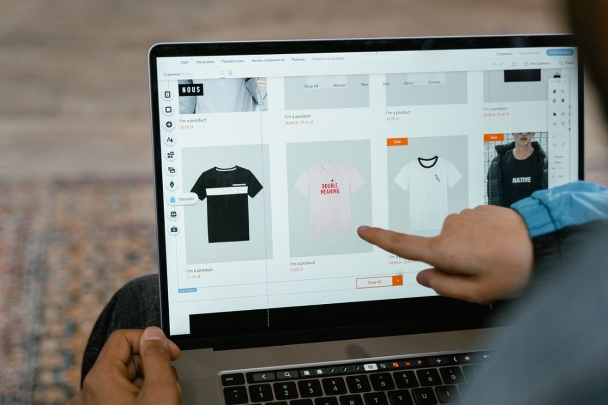 Website builder open on a laptop showing an ecommerce product grid